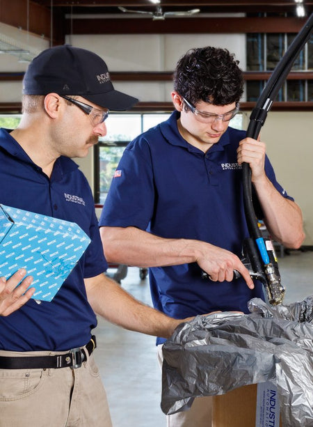 Industrial Automation Co. technicians inspecting a part